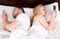 Couple socialising with mobile phones in bed