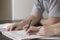 Couple Solving Sudoku In Newspaper At Desk