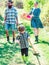 Couple with son gardening in the backyard garden. Rural family scene. Family work in South America with livestock in