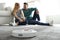 Couple spending time together while robotic vacuum cleaner doing its work