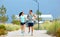 Couple in sports clothes running along beach path