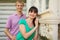 couple stand near wooden village house