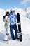 Couple stand with snowboard