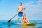 Couple Stand Up Paddle Surfing In Hawaii