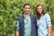 Couple standing amidst vines