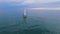 Couple standing at bow of white sailing boat amidst ocean, future life, family