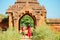 Couple standing at door of Myanmar pagoda ruin