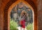 Couple standing at door of Myanmar pagoda ruin