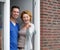 Couple standing by door of new home holding keys