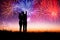 Couple standing on the hill and watching the fireworks