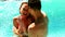 couple standing in the pool on holidays