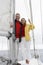 Couple Standing On Sailboat