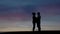 Couple standing on sky background.