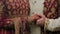 Couple standing together and hold hands together dressed in traditional Indian hindu wedding