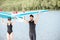 Couple with standup paddleboard on the beach