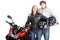 Couple stood with motorcycle