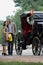 Couple stood next to horse drawn carriage