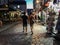 Couple strolls nighttime Montmartre cobblestone street