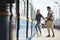 couple of stylish tourists with backpacks and map going into train at outdoor metro