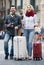 Couple with suitcases, camera and map outdoors