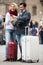 Couple with suitcases, camera and map outdoors