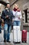 Couple with suitcases, camera and map outdoors