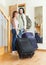 Couple with suitcases near door