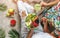 Couple in summer clothes holding fresh salad with quinoa, peach, greens, avocado, berries, melon in bowl on light background with