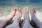 Couple in the summer holidays: Feet in the crystal clear water