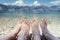 Couple in the summer holidays: Feet in the crystal clear water