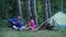 Couple summer picnic. Company camp. Having camping in forest. Outdoor leisure.