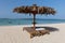 Couple of sun beds and a parasol on a sandy beach