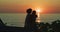 Couple, sunset and car with hug, silhouette and beach to relax with love outdoor, summer and dusk. People, vehicle and
