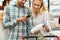 Couple in supermarket reading shopping list