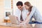 Couple surfing the internet in the kitchen