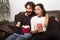Couple is surprised by the movie. They so sitting on the sofa at
