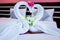 Couple swans made by white towel on the bed in the hotel room. I