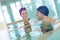 Couple swimmers swimming in indoor swimming pool