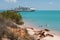 Couple swimming with dogs modern cruise ship tied up to jetty.