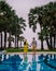 Couple in swimming pool during a luxury vacation in Thailand, men and woman at luxury hotel resort in Thailand holiday