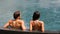 Couple in swimming-pool relaxing at hotel resort vacation travel