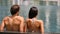 Couple in swimming-pool relaxing at hotel resort vacation travel