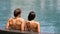 Couple in swimming pool relaxing at hotel resort vacation travel