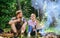 Couple take break to eat nature background. Couple in love camping forest hike. Food for hike and camping. Couple sit