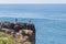 Couple taken picture over cliff and ocean in Cascais