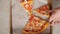 Couple takes delicious colorful pizza slices from craft box