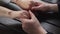 Couple takes each other`s hands sitting at a wooden table