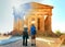 Couple taking photos of Temple of Concordia in Agrigento in Sicily, Italy. Special sun flare