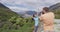 Couple taking pictures in nature landscape on New Zealand travel by lake Hawea