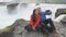 Couple Taking Selfie Against Godafoss Waterfall - Tourist Destination Iceland